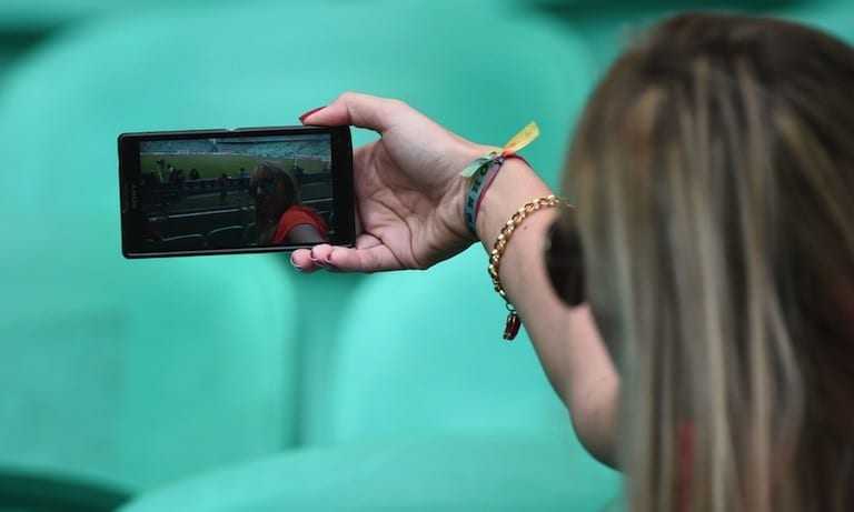 A Netherlands' fan takes a selfie as she awaits the kick-off of the quarter-final football match between Netherlands and Costa Rica at the Fonte Nova Arena in Salvador during the 2014 FIFA World Cup on July 5, 2014.  AFP PHOTO / DAMIEN MEYERDAMIEN MEYER/AFP/Getty Images